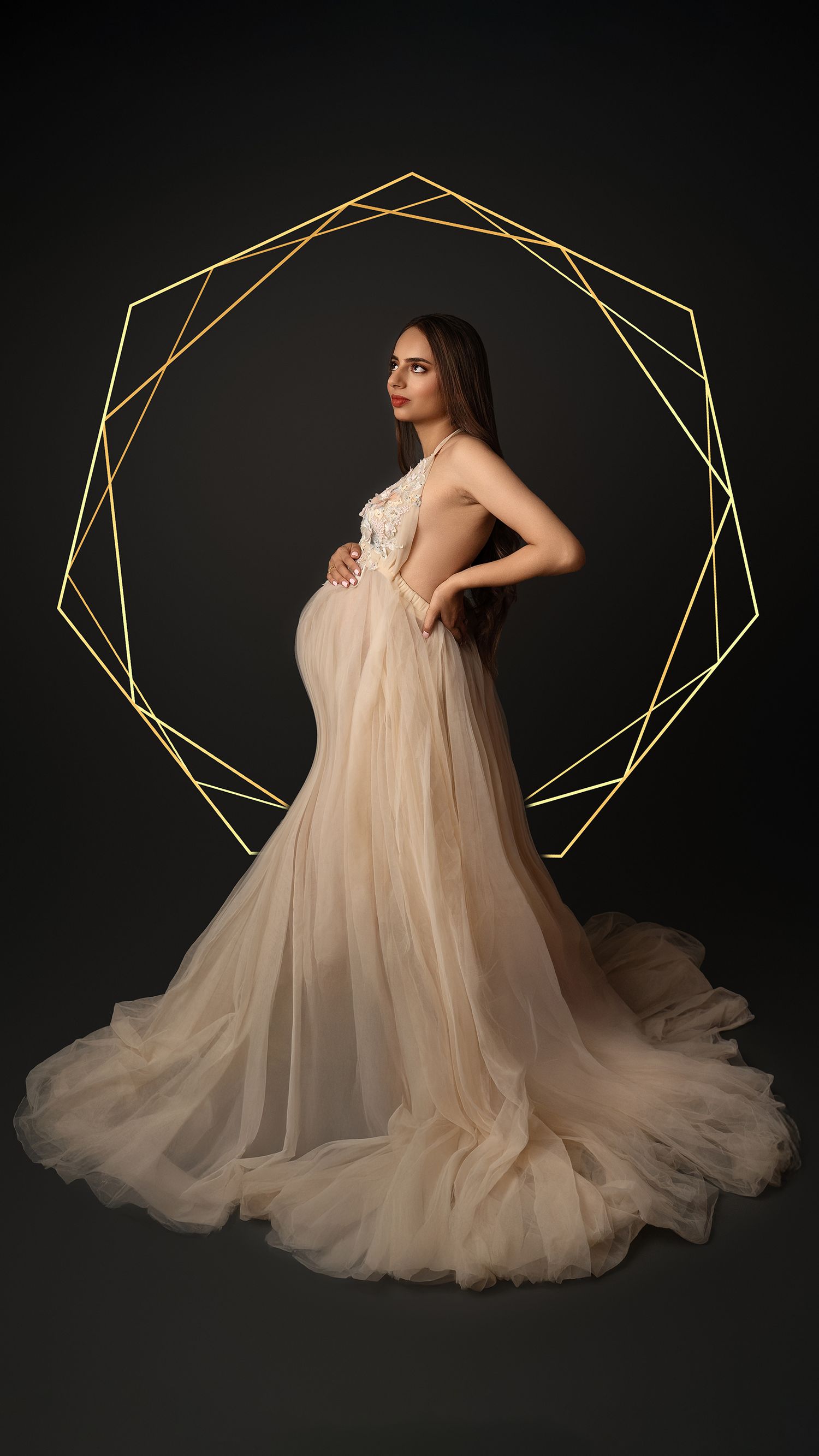 Elegant indoor maternity portrait of expectant mother at 32 weeks pregnant in London studio