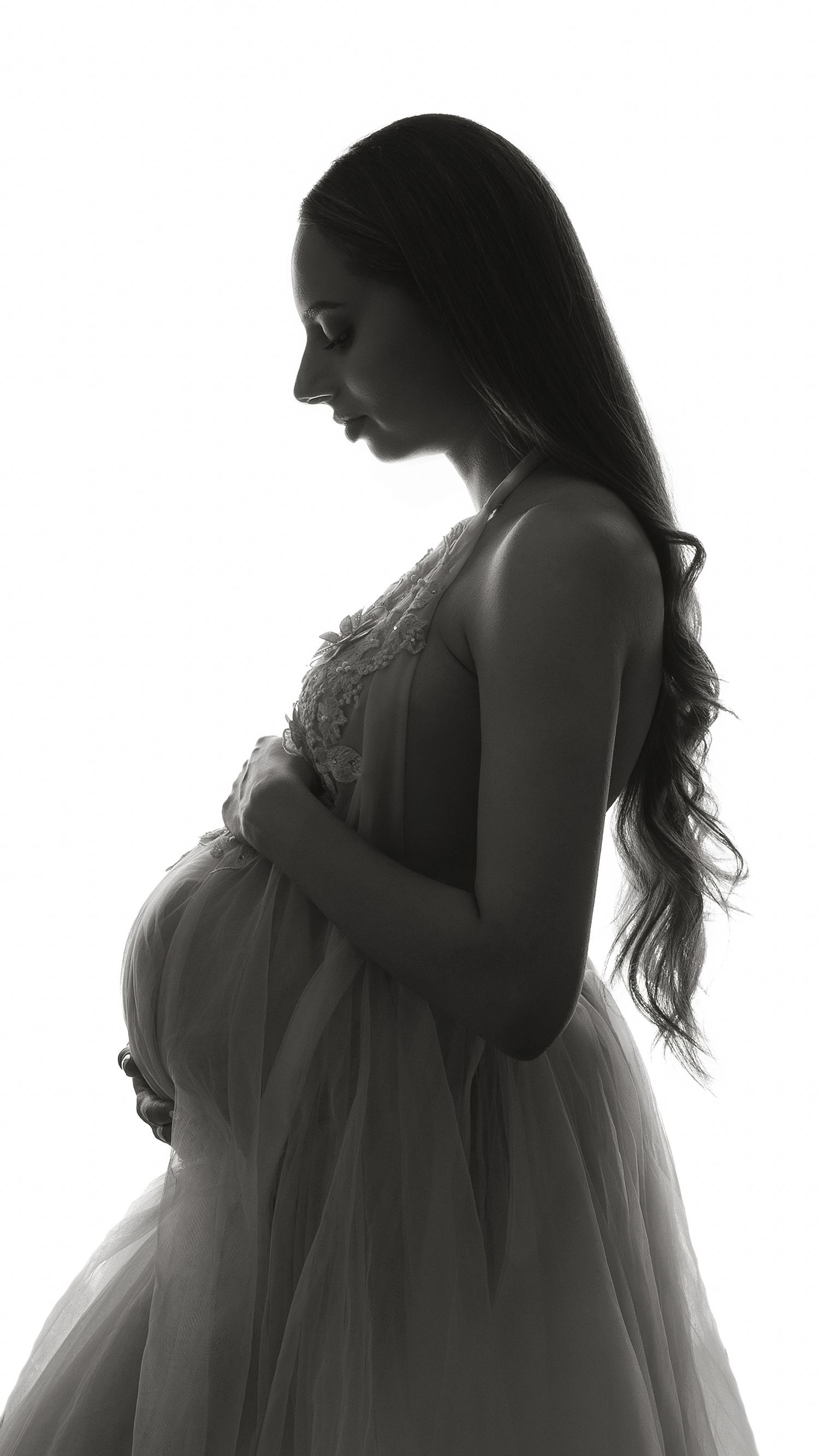 Pregnant woman in flowing gown during maternity photoshoot at West London studio in Hayes