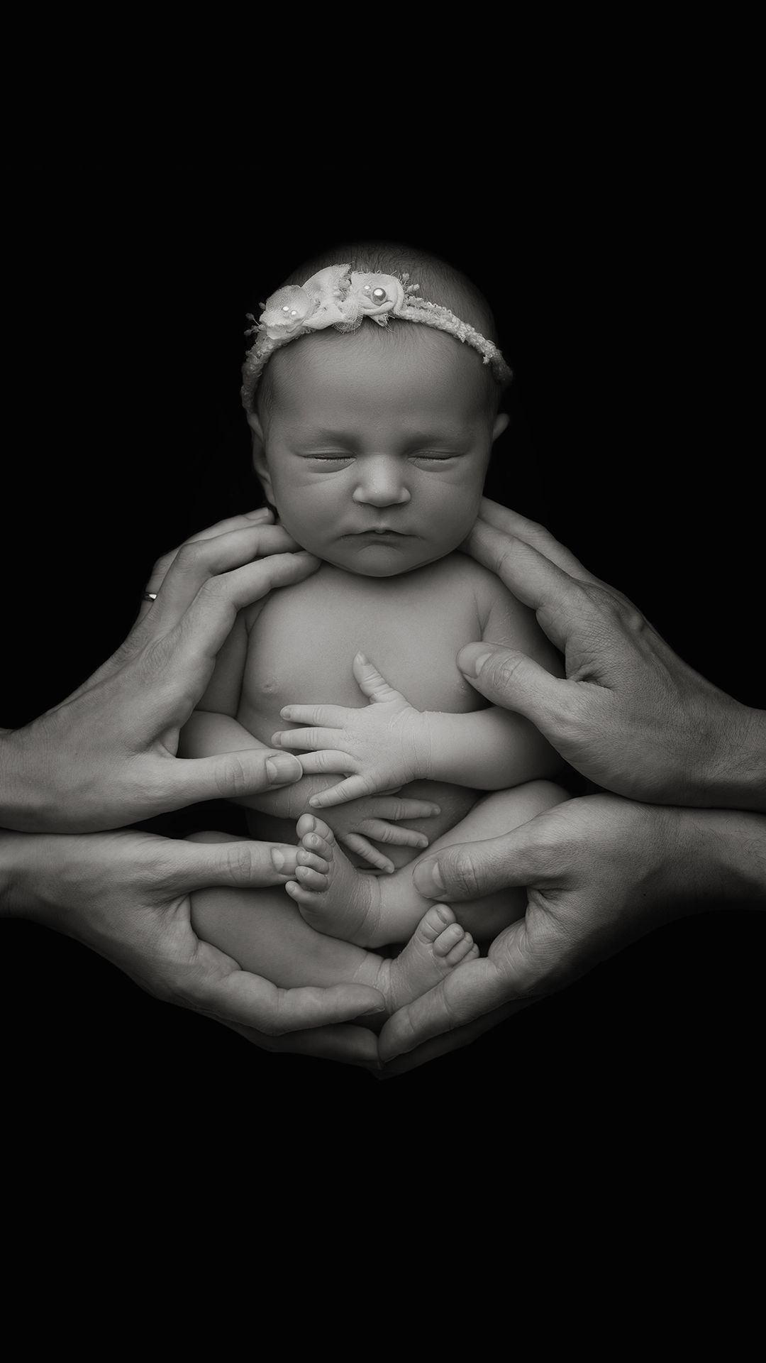Close-up newborn photo highlighting tiny fingers and delicate features in Hayes