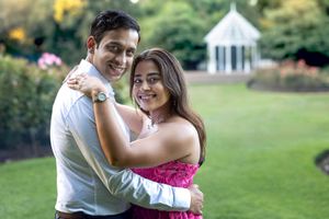 Engaged couple show off Engagement Ring in Hamilton rose garden at sunset