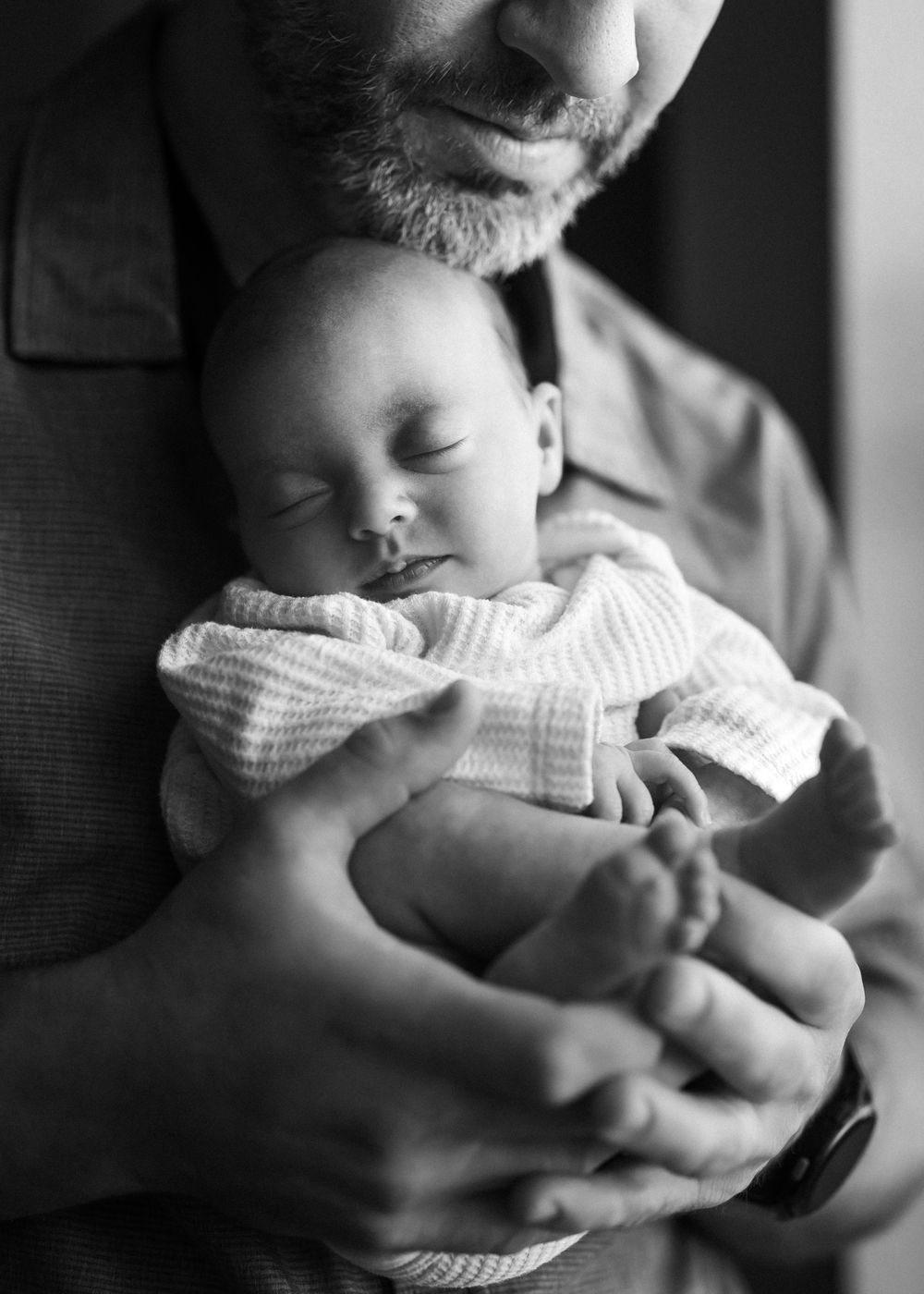 Black and white photo series showing intimate moments between parent and newborn baby in hospital setting.