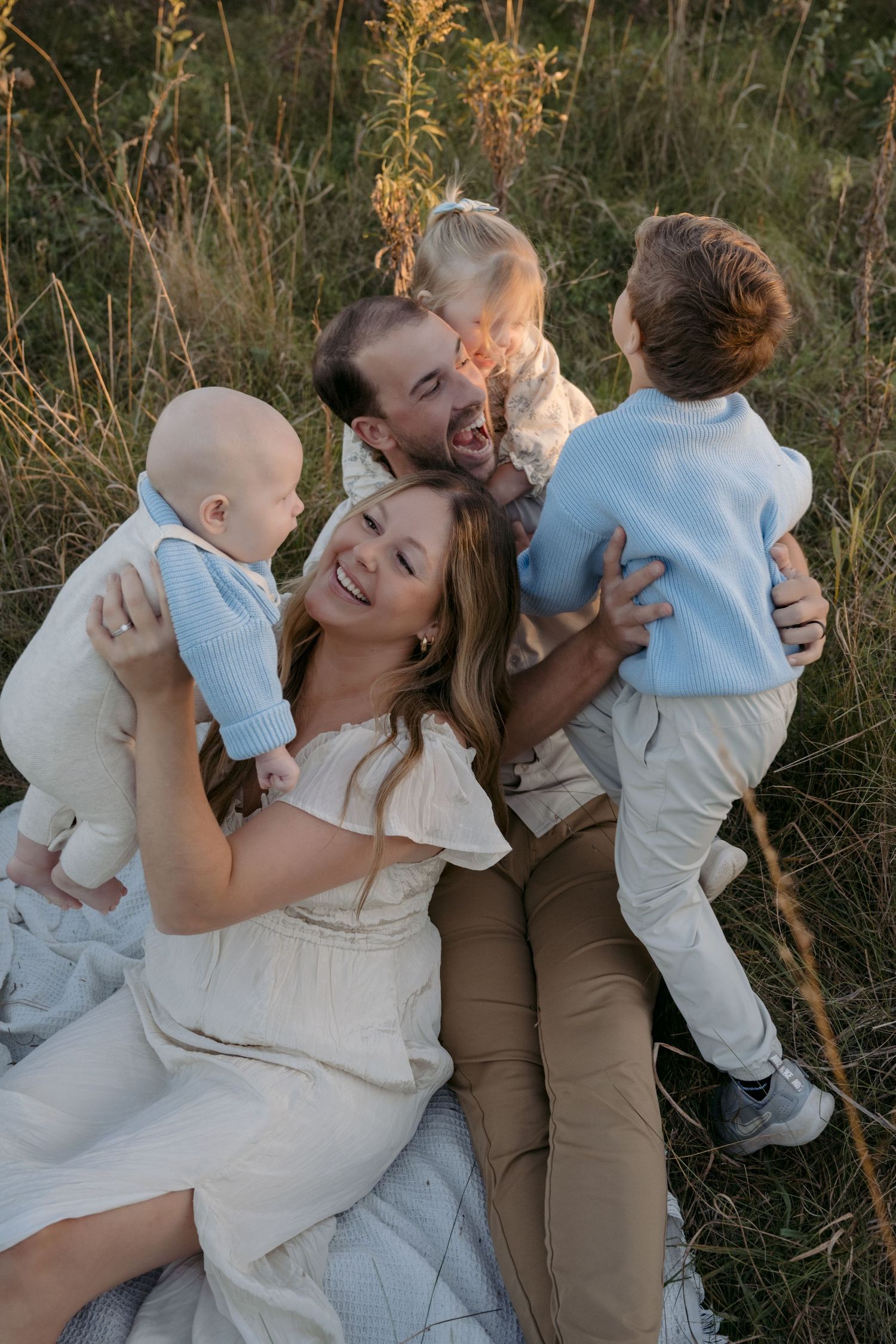 family session on a grassy hill for family photography session in Hudson Wisconsin