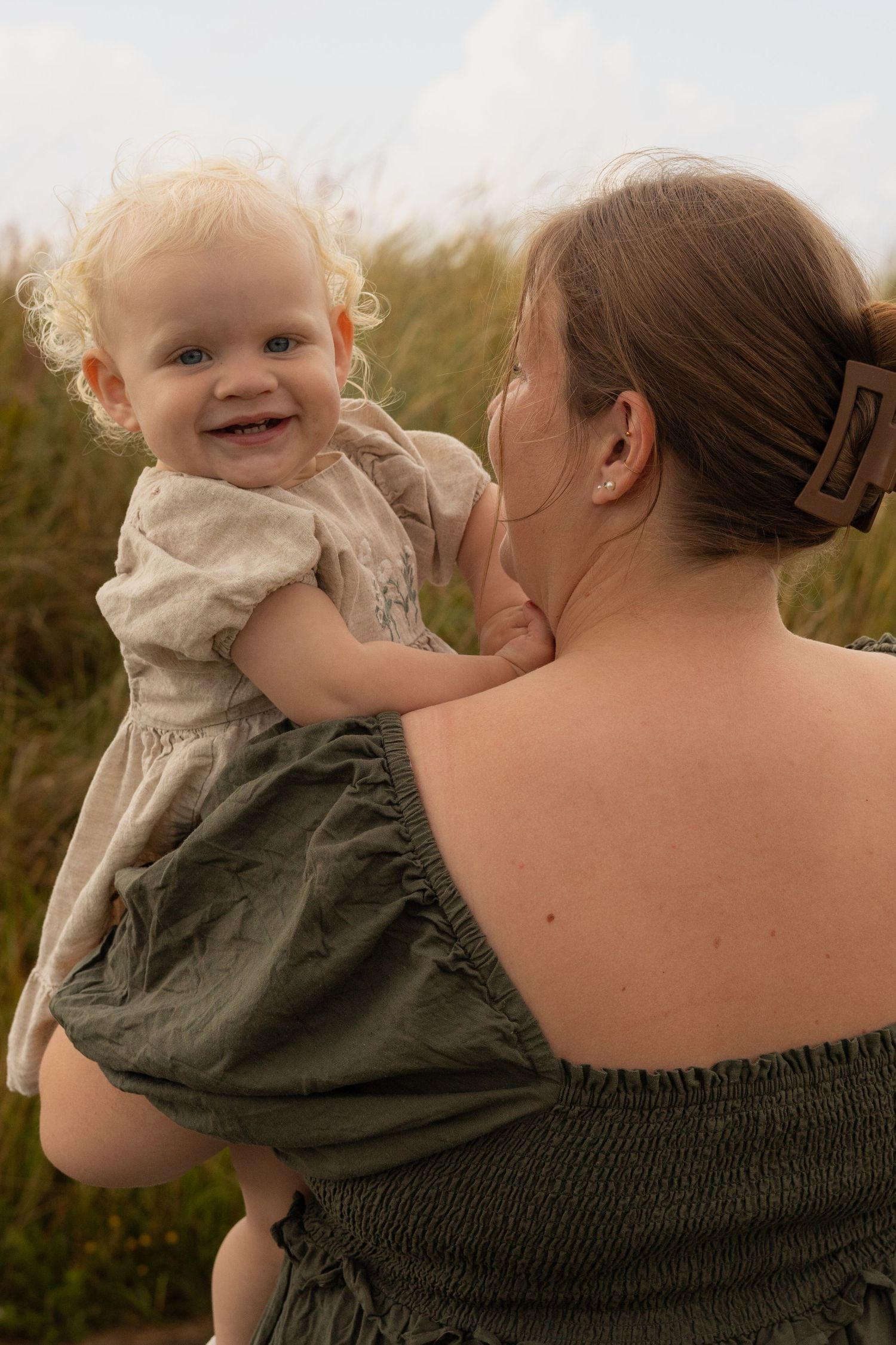 Joyful moment between parent and child outdoors in natural setting.