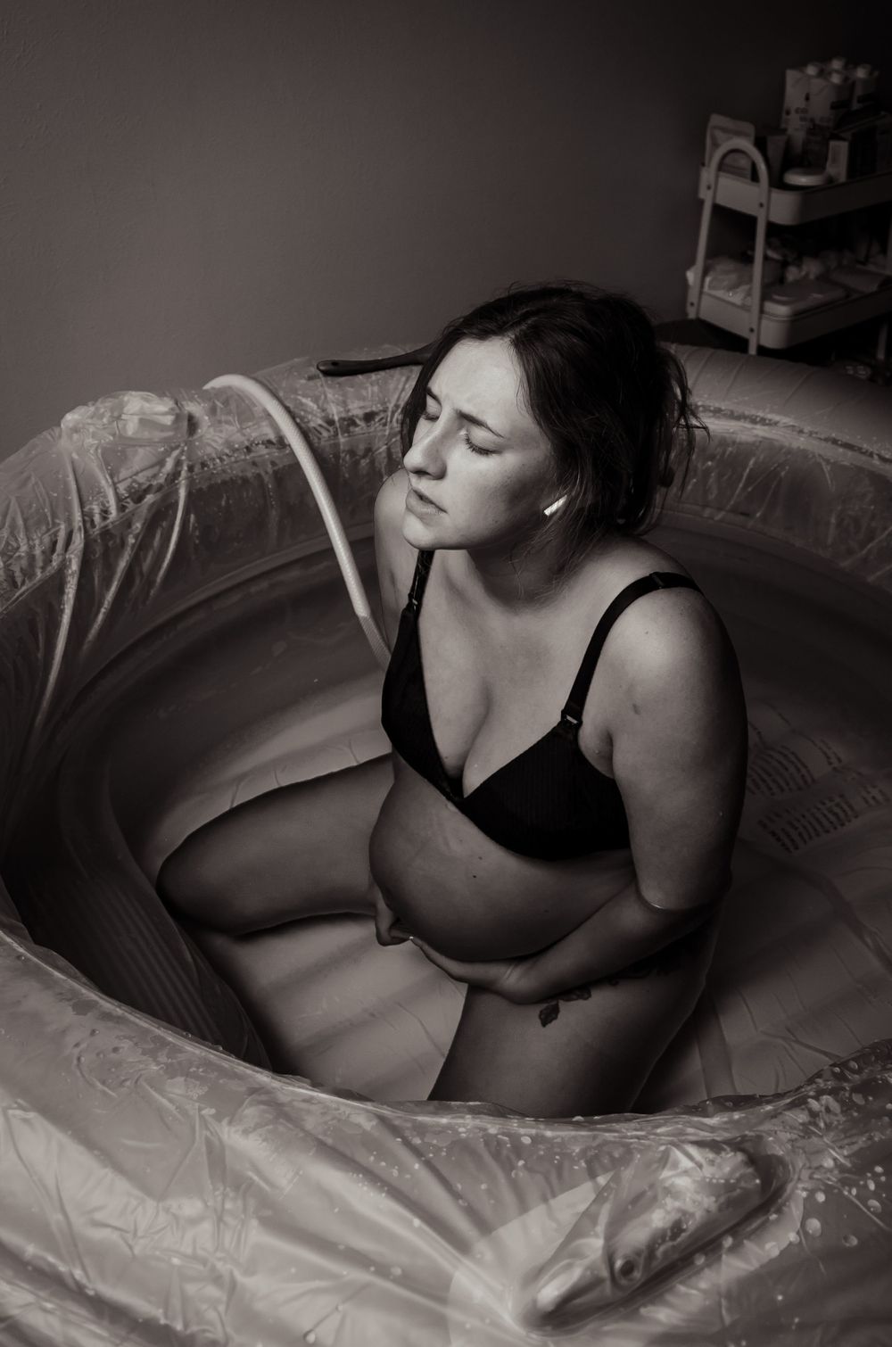 Expecting mother rests peacefully in birthing pool during labor.