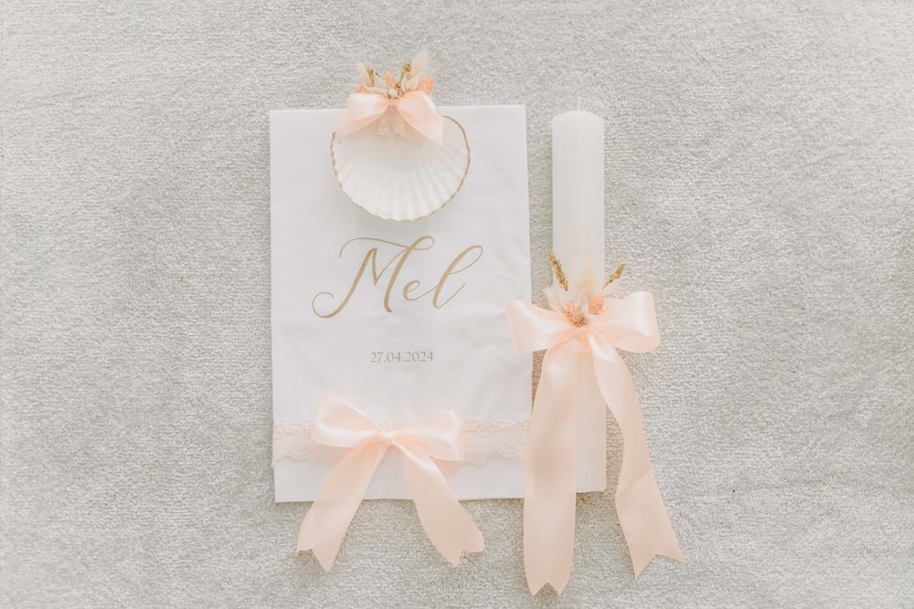 White wedding stationery with peach ribbons and elegant gold text.