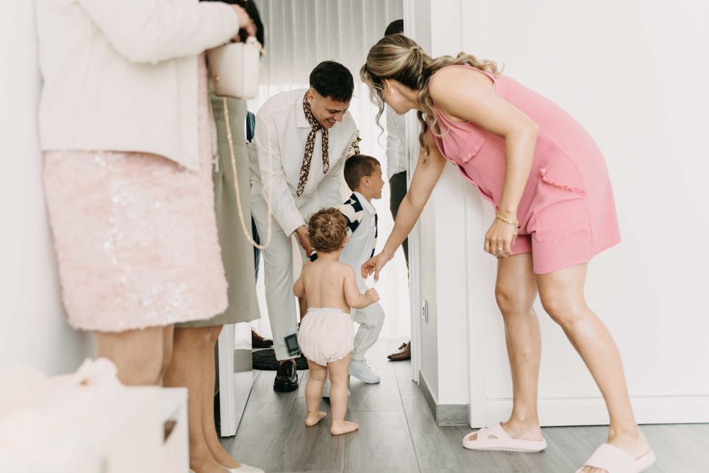 Family getting ready scene reflected in full-length mirror.