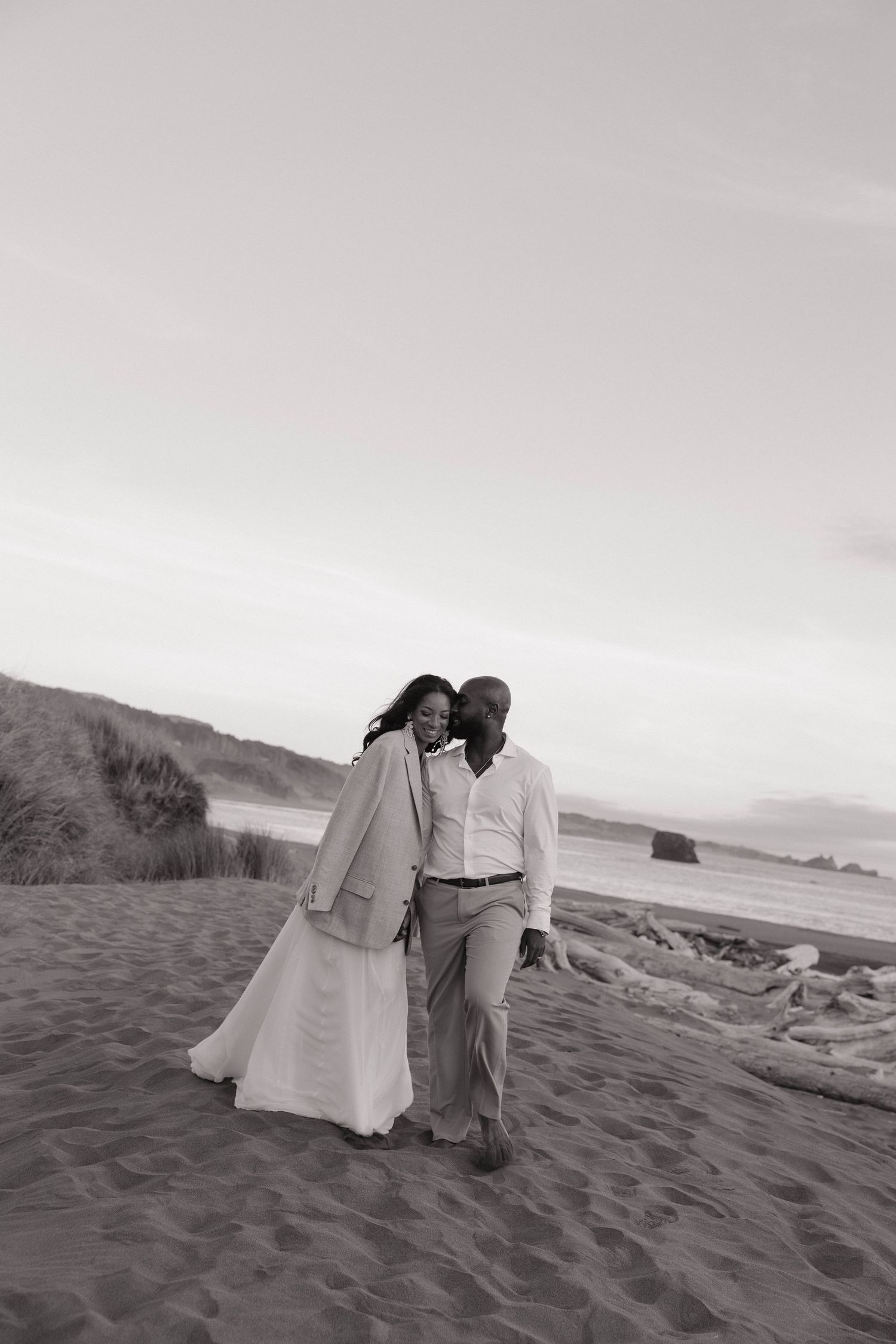 couple walking on the beach on the oregon coast