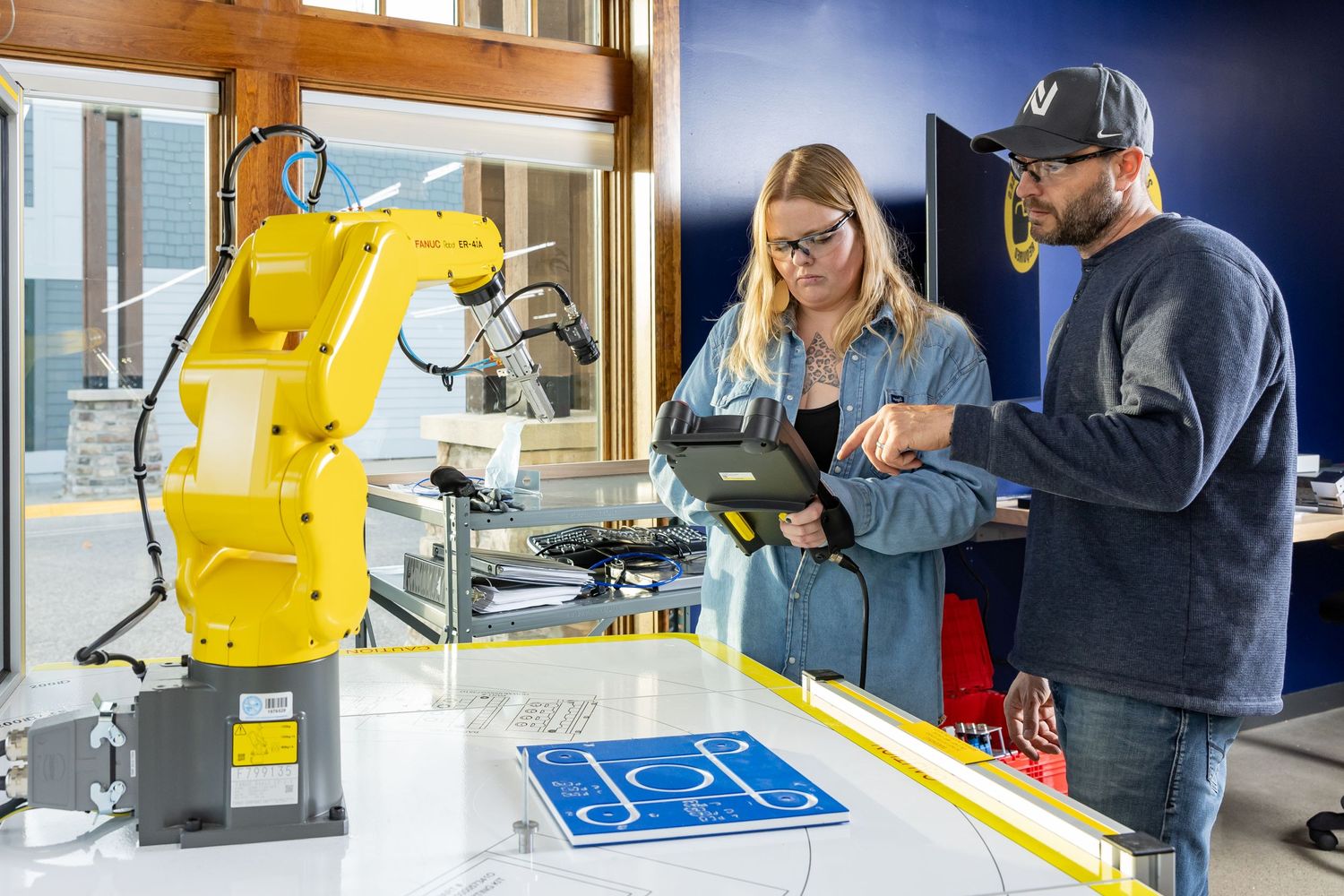 Industrial robotics equipment and machinery being operated in a manufacturing facility.