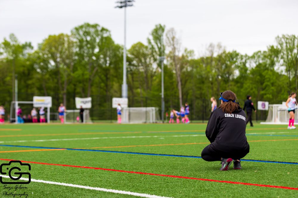 field hockey coach kneeling on sidelines southern maryland eliminators game action photo coverage maryland dmv suzi gibson photography