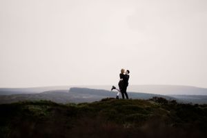 A tender moment suspended in time — love standing tall against the vast horizon.