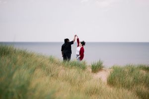 A tender moment captured in the dunes — a soft, timeless and intimate. LGBTQ+