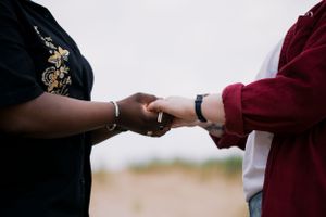A tender moment captured in the dunes — a soft, hands held, timeless and intimate. LGBTQ+