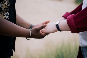 A tender moment captured in the dunes — a soft, hands held, timeless and intimate. LGBTQ+