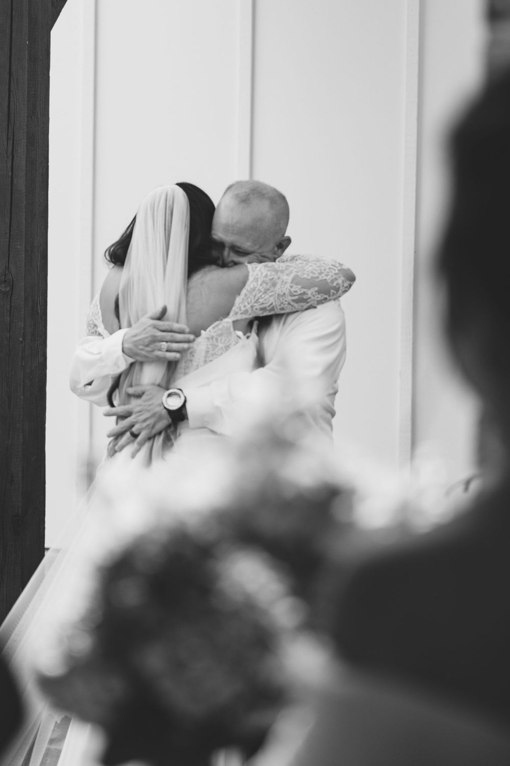 Black and white photo capturing an intimate embrace during a wedding ceremony. The Bradford, Separk  Mansion, Graylyn Estate