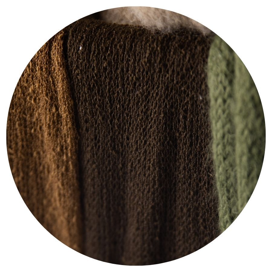 Close-up of brown and olive green knitted fabric textures side by side.