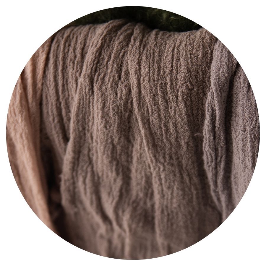 Close-up of soft taupe brown wool yarn with natural fiber texture.