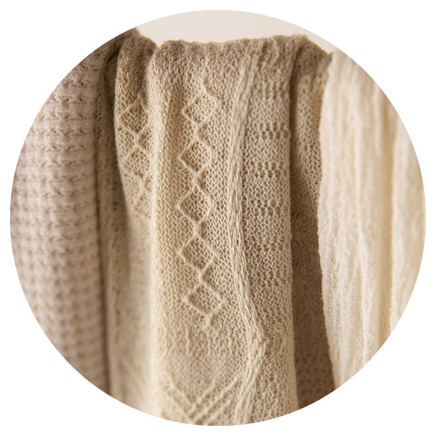 Beige knitted fabric swatches with diamond lace pattern in neutral cream tones.