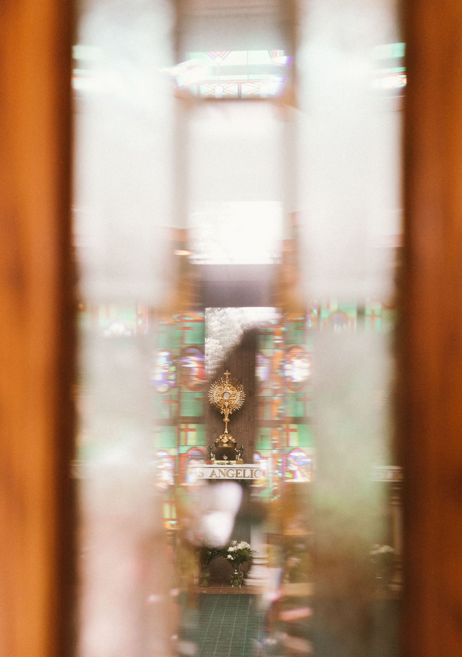 Blurred artistic view through glass with golden tones and decorative elements.