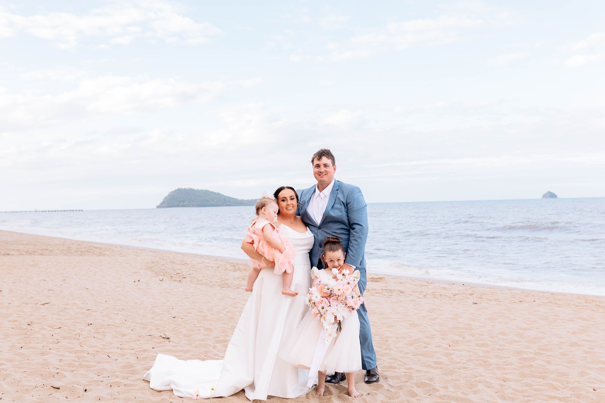 Romantic beach wedding photography session with soft pastel colors and ocean views.