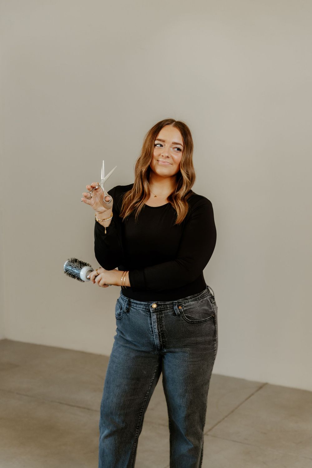 Western Studio portrait series showing poses in black top and jeans against a gray background.