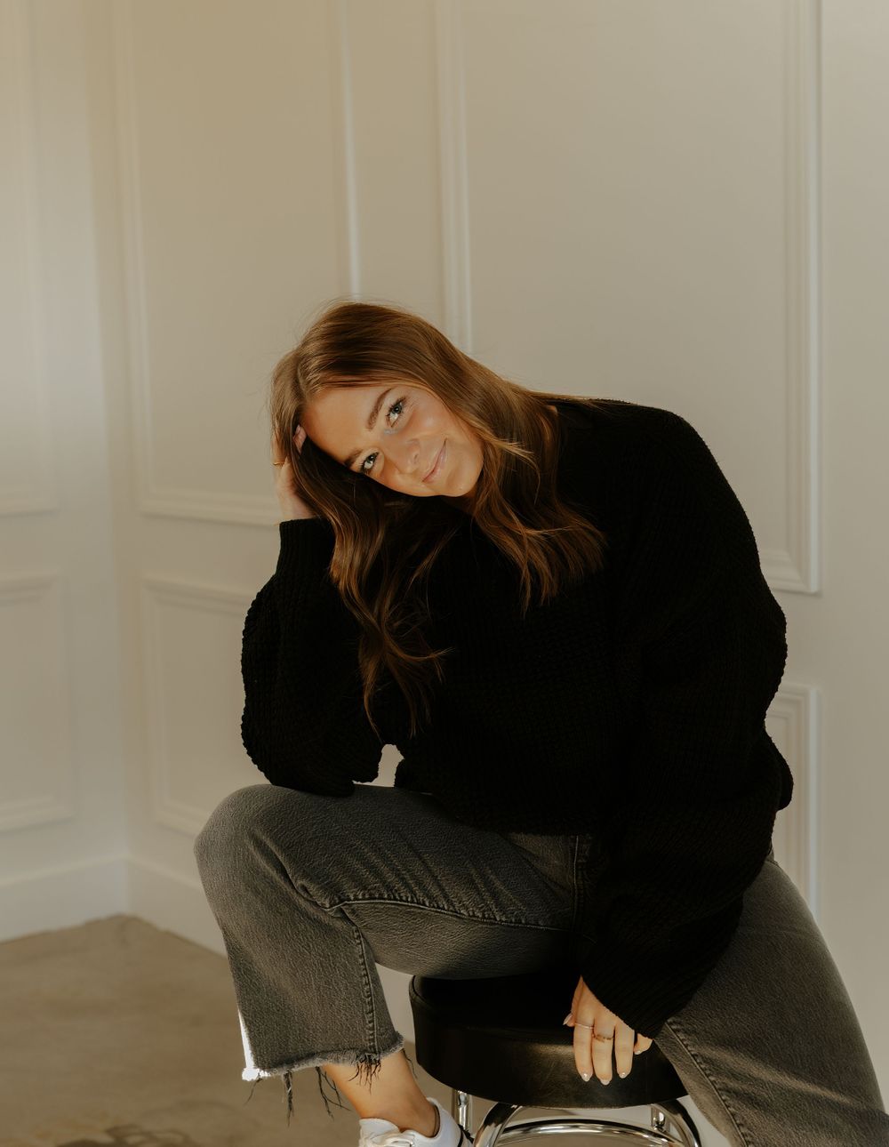 Hairstylist Creative indoor portrait sequence showing casual poses in black outfit and jeans.