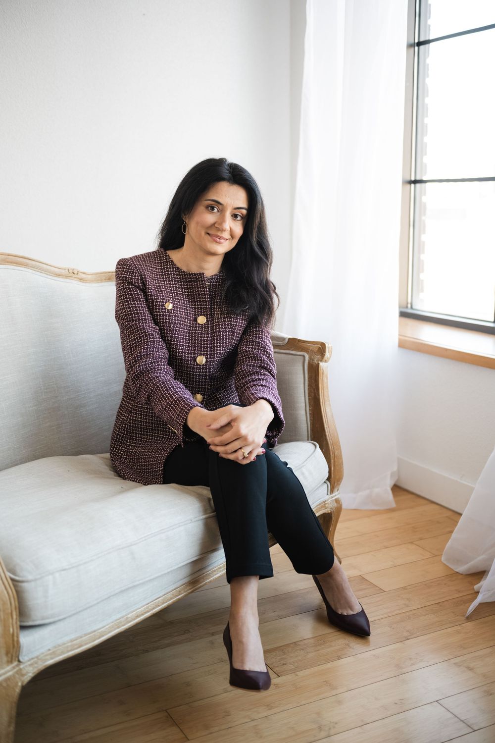 A series of four photos showing someone seated on a white couch in a bright, minimalist room with wooden floors.