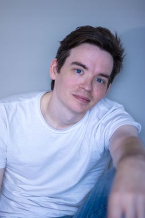 Portrait of young man in a white shirt taken in Petersburg Virginia by Chris Suits Photography.