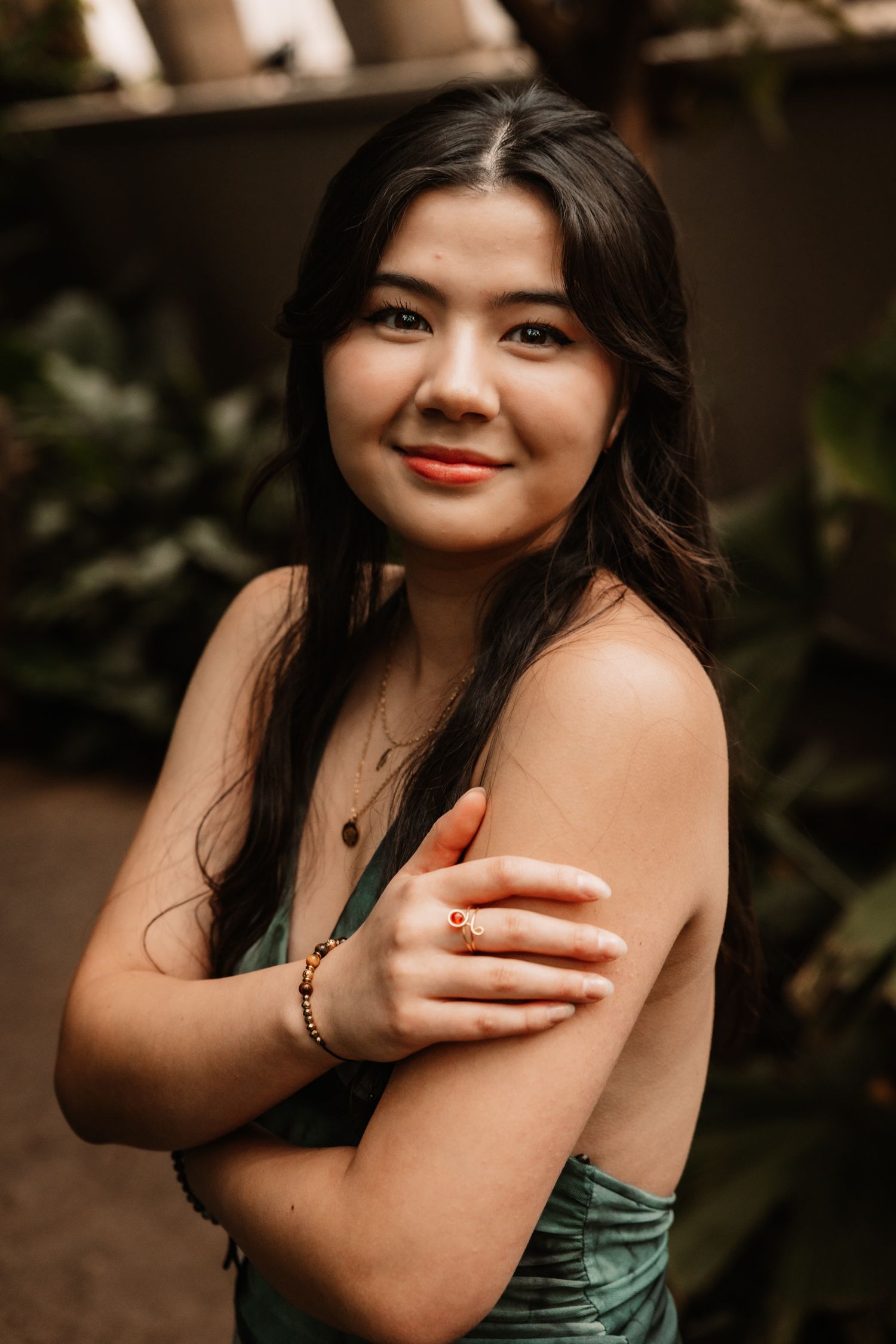 Portrait photography series showing a person in a green top against a dark moody background.