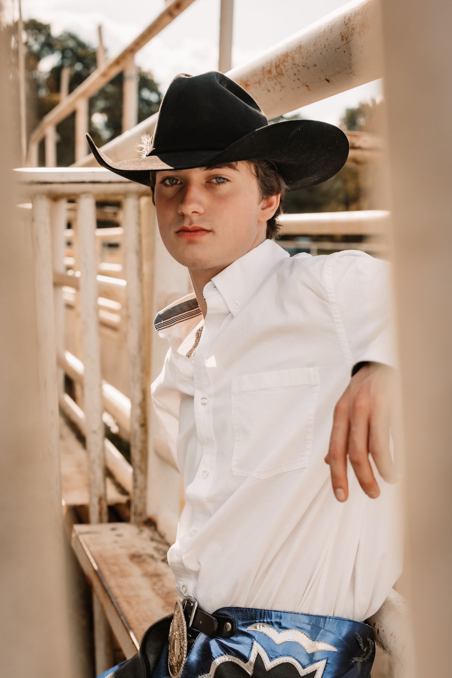 A series of sepia-toned portraits showing someone wearing a white shirt and black cowboy hat in a rustic setting.