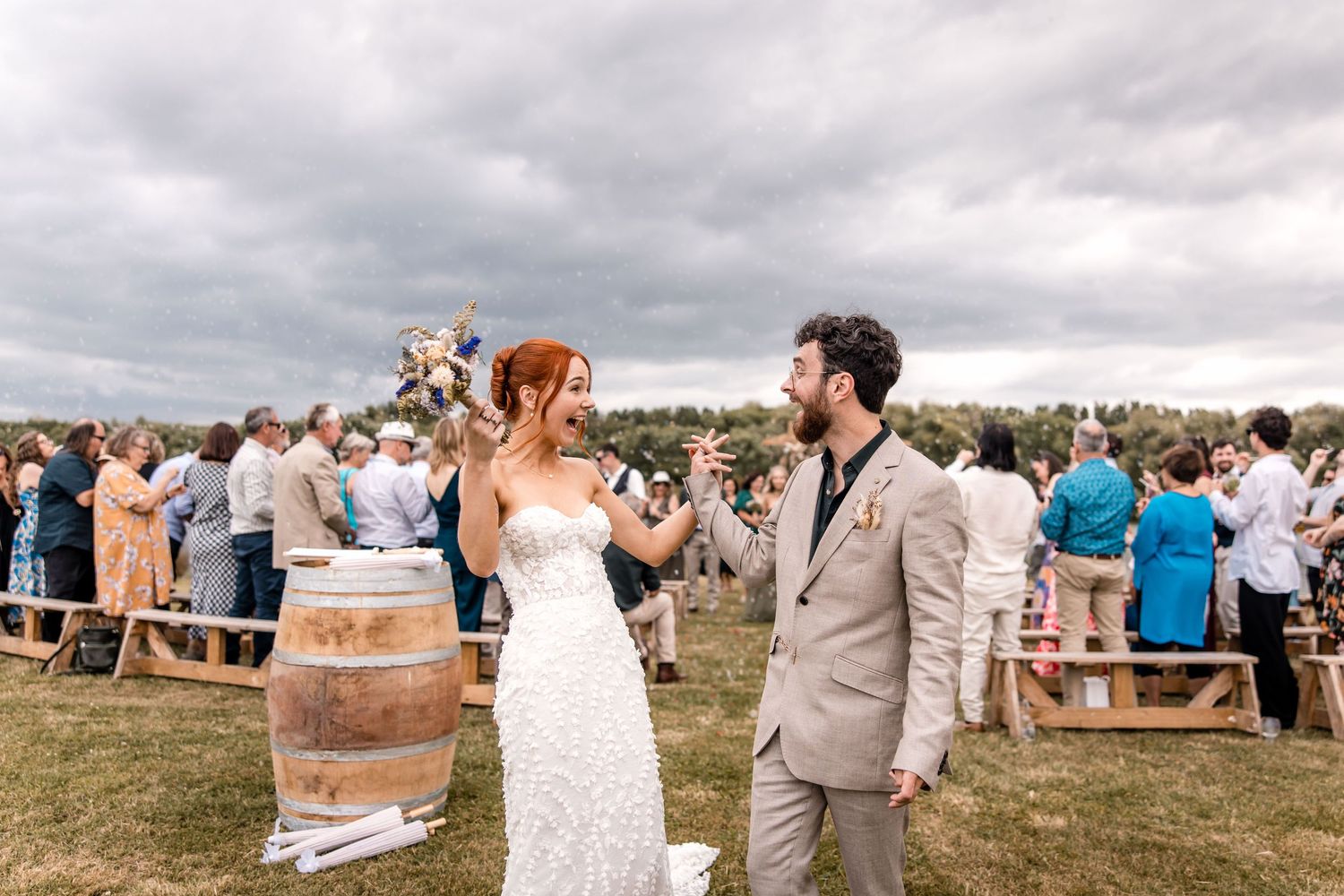 happy fun bride groom excitement at end of isle Back Paddock Lakes