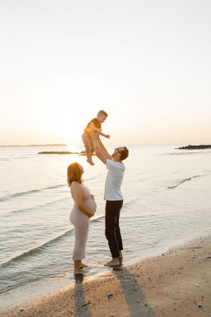 Family enjoying sunset on the Hilton Head Island beach in South Carolina during a golden hour photoshoot with B. Logsdon Photography.