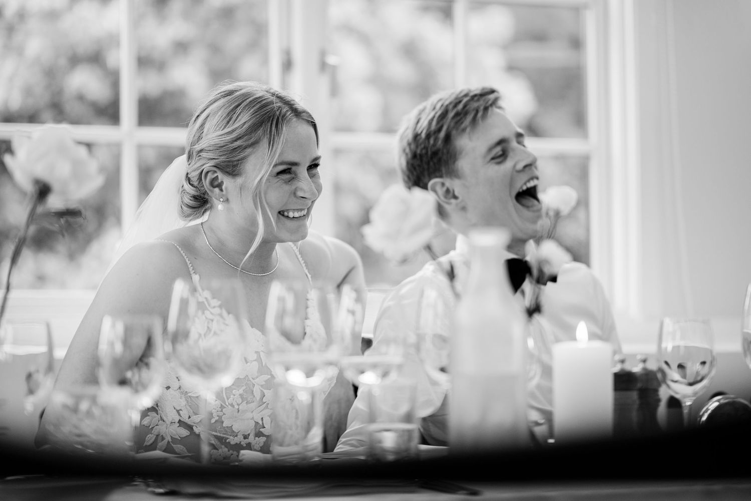 A romantic wedding portrait of newlyweds embracing in a lush green forest setting.