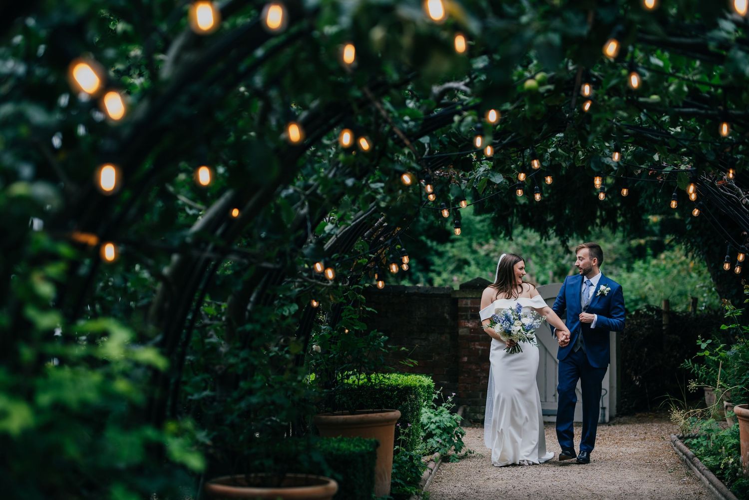 Intimate wedding portrait of couple in wildflower field.