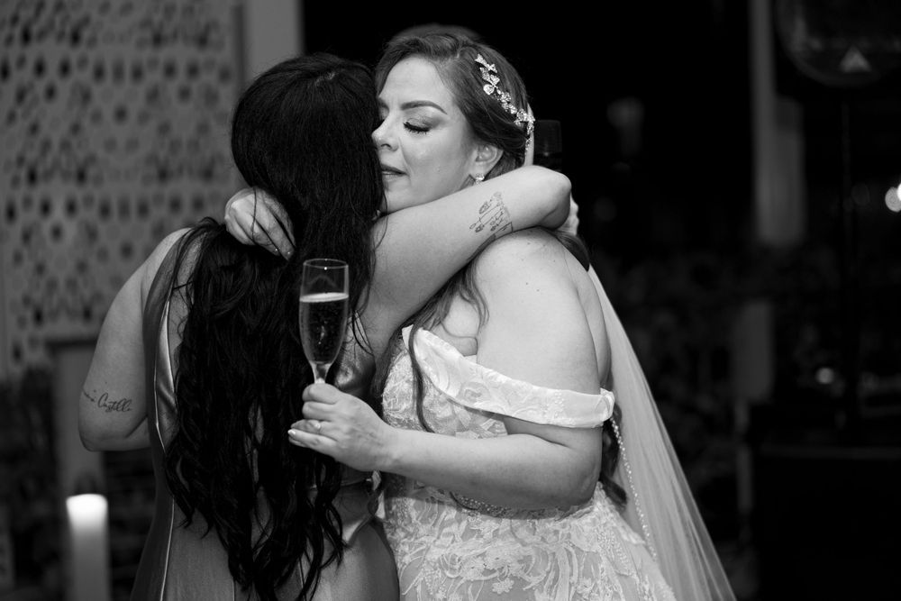 Wedding celebration moment with two people embracing on the dance floor.