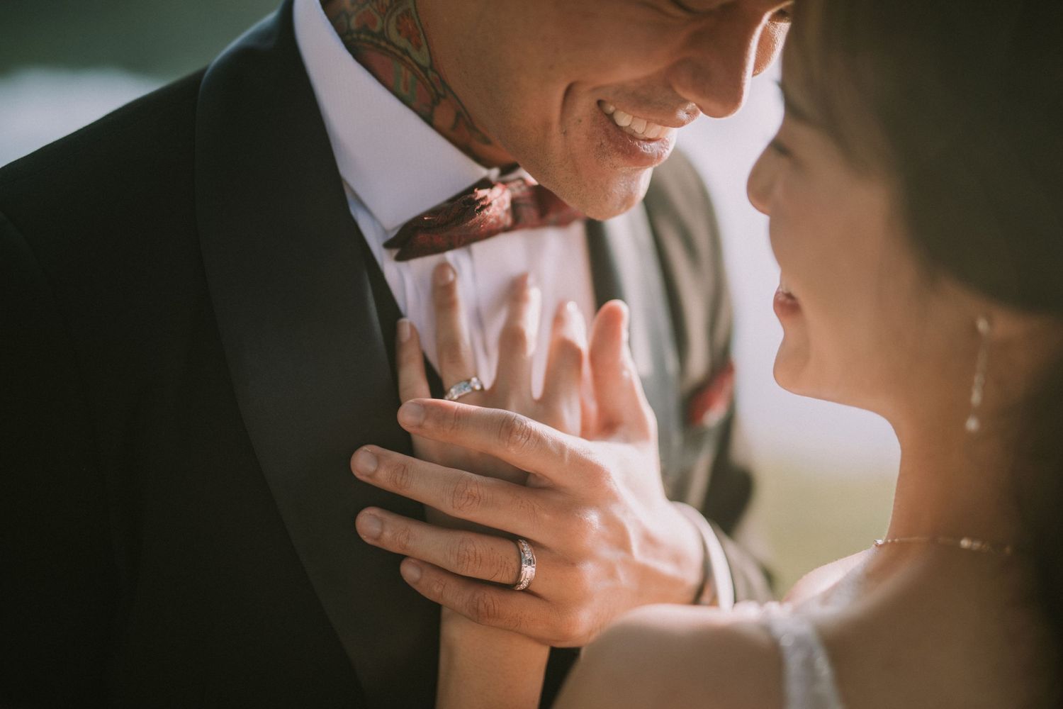 Wedding couple shares emotional moment in soft natural lighting outdoors.