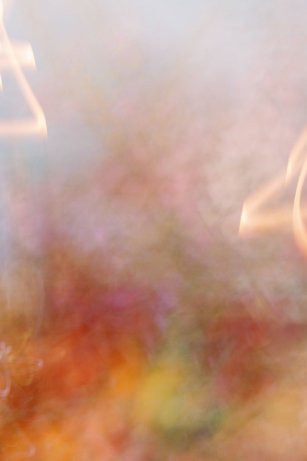 Abstract blurred image with warm orange and pink tones creating a dreamy atmosphere.