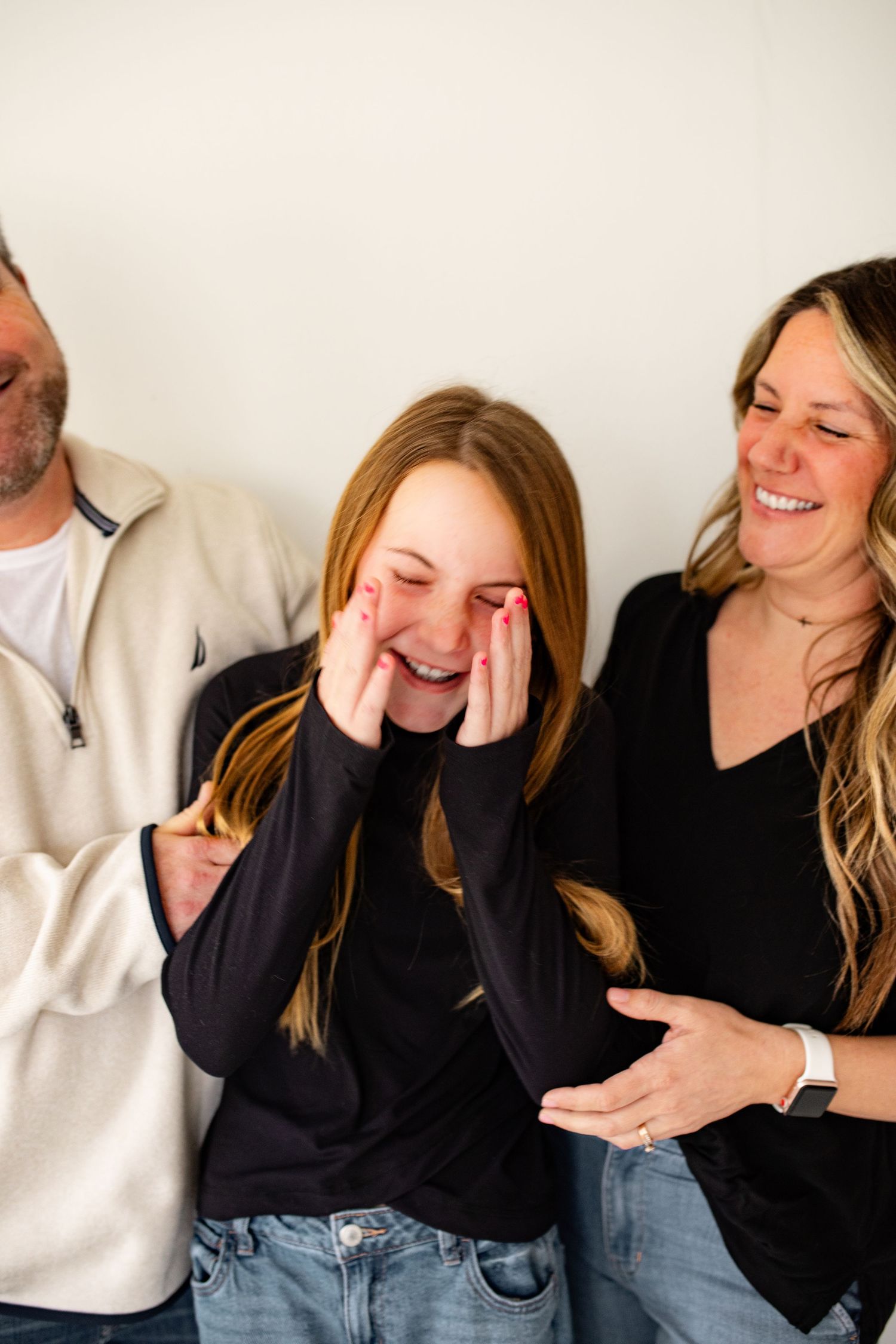 A series of candid photos showing people laughing and expressing joy while wearing casual black and white clothing.