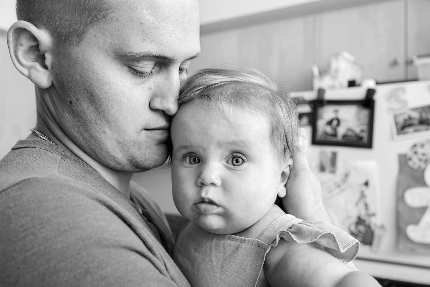 Close up of a dad nuzzling his infant daughter.(Black and white). Doughman Photography.