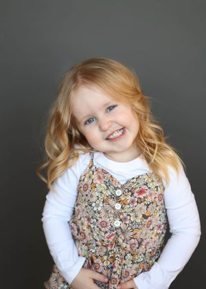 Candid portrait sequence showing joyful expressions in a floral outfit.