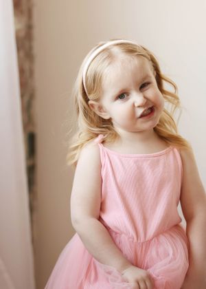 Sequential photos of twirling and dancing in a pink sleeveless dress.