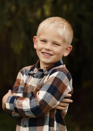 Playful sequence of poses with plaid shirt against dark forest background during outdoor photoshoot.
