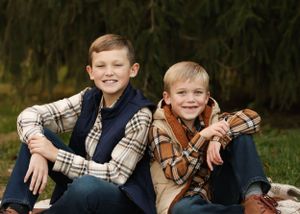 Candid outdoor portraits showing joyful interaction between two young people in casual attire.