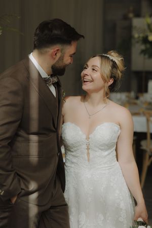 A romantic moment between newlyweds as they share laughter and loving glances during their wedding photoshoot.