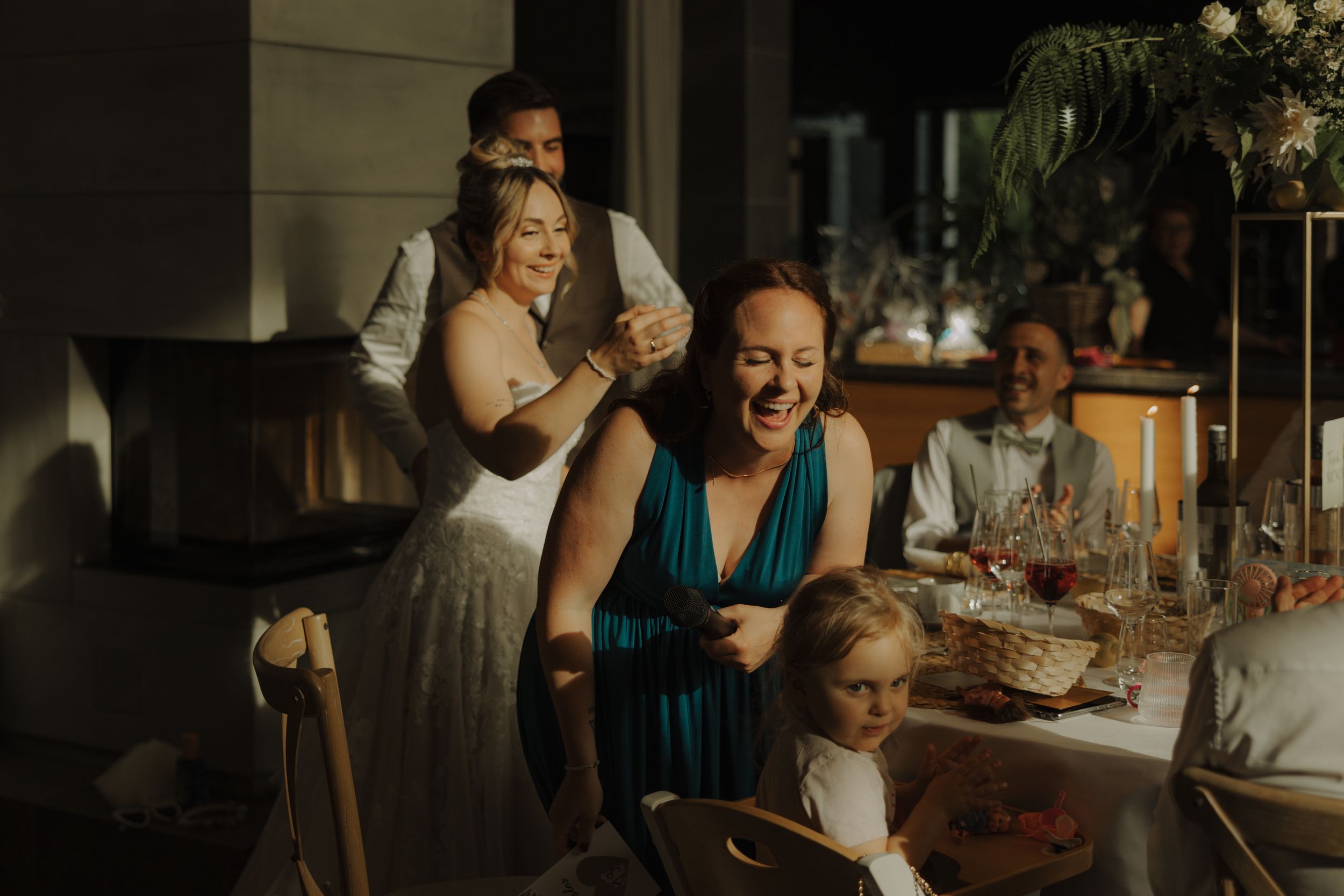 A group of friends enjoying drinks and conversation at a lively restaurant table.