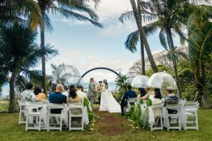 Outdoor wedding ceremony in Kualoa Ranch, Oahu, Hawaii. Wedding under the rain