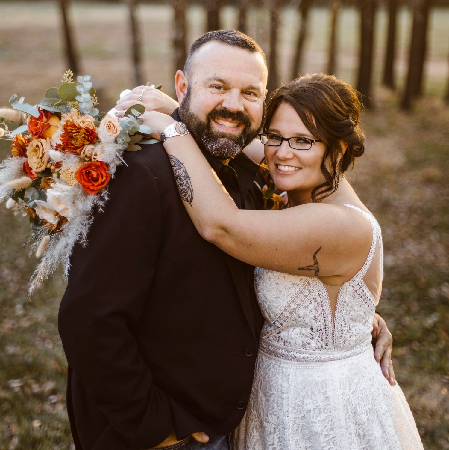 Outdoor casual portrait at rustic wooden fence in countryside setting.