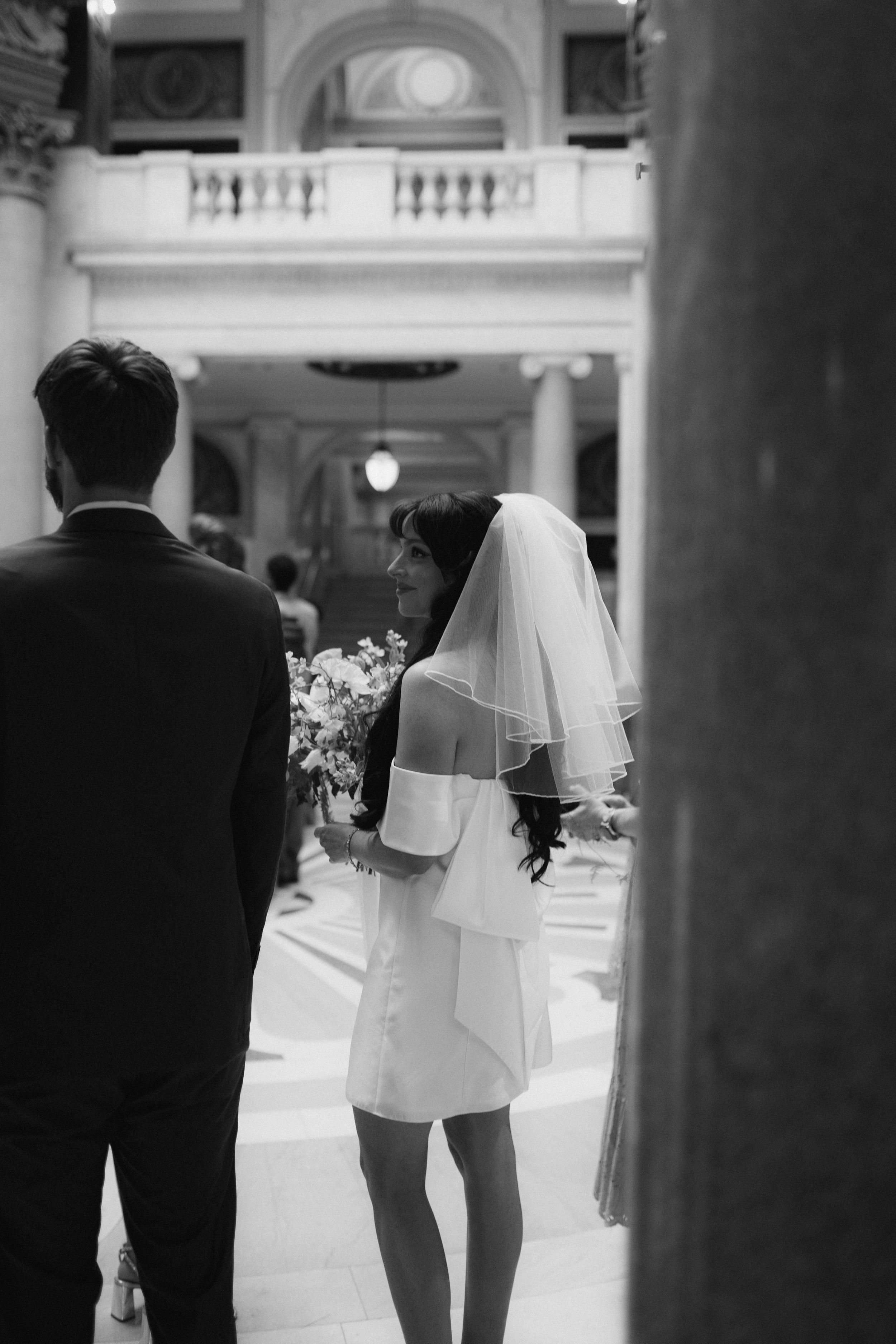 Black and white photo capturing movement through elegant columns.