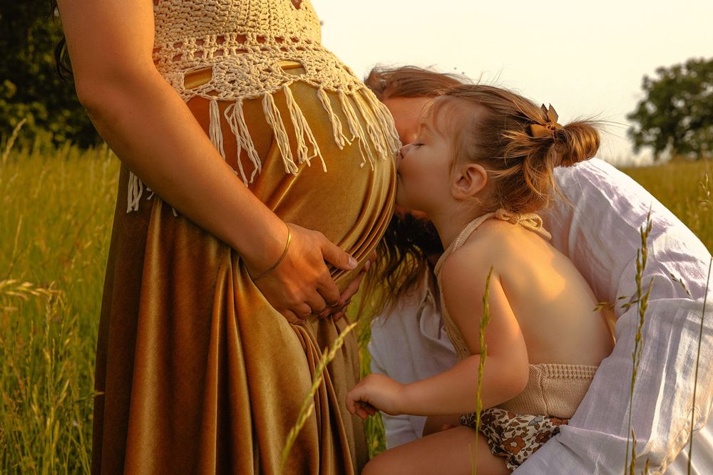 A sweet family moment captured in a golden wheat field at sunset.