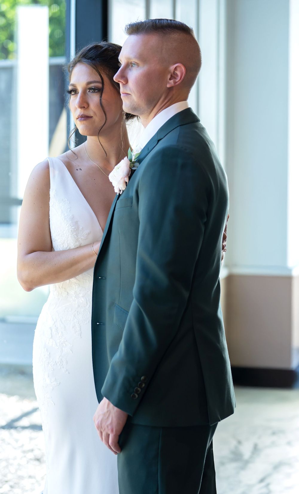 Elegant indoor wedding portraits in a bright white venue with classic architecture.