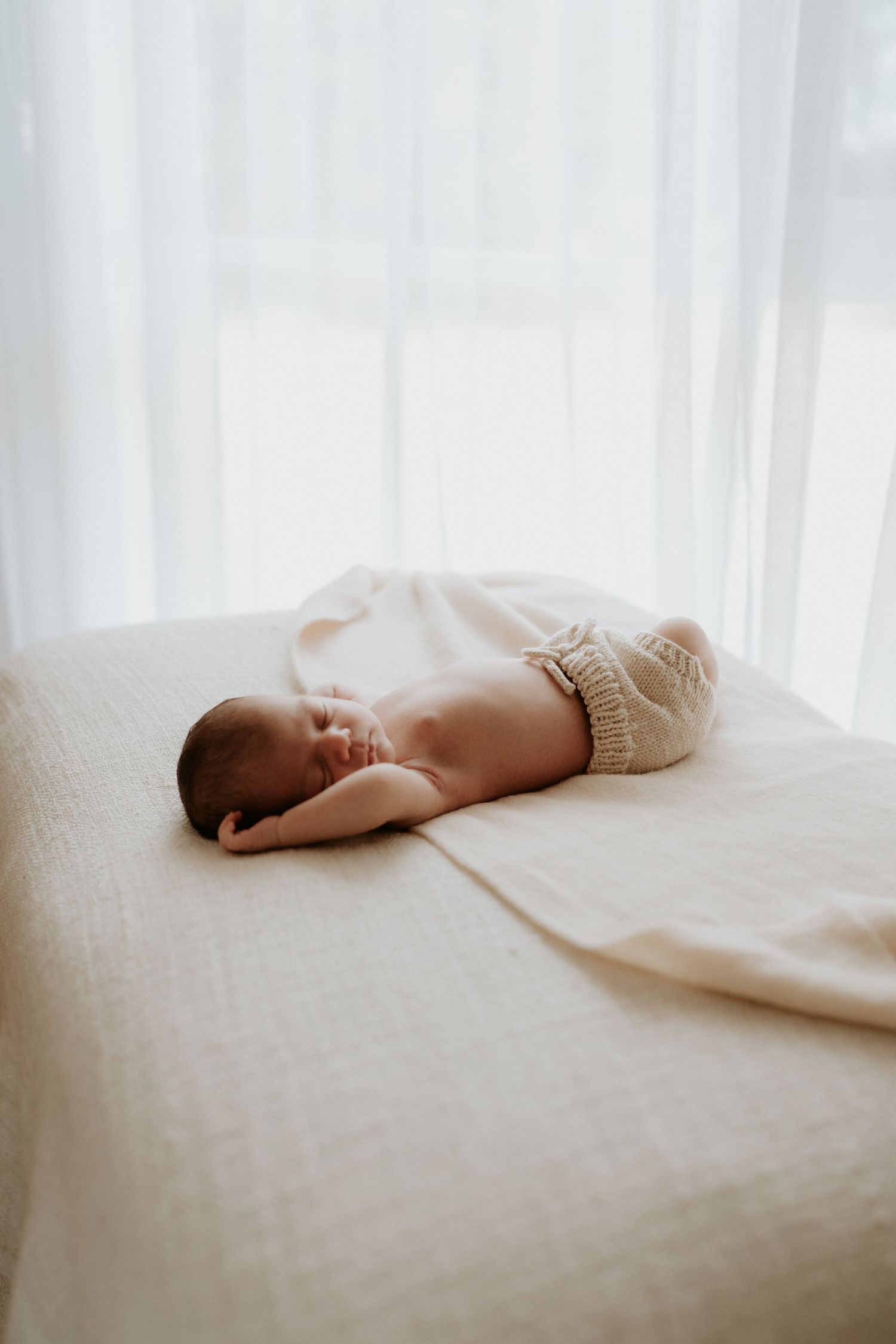 A natural professional photo of a newborn baby at home